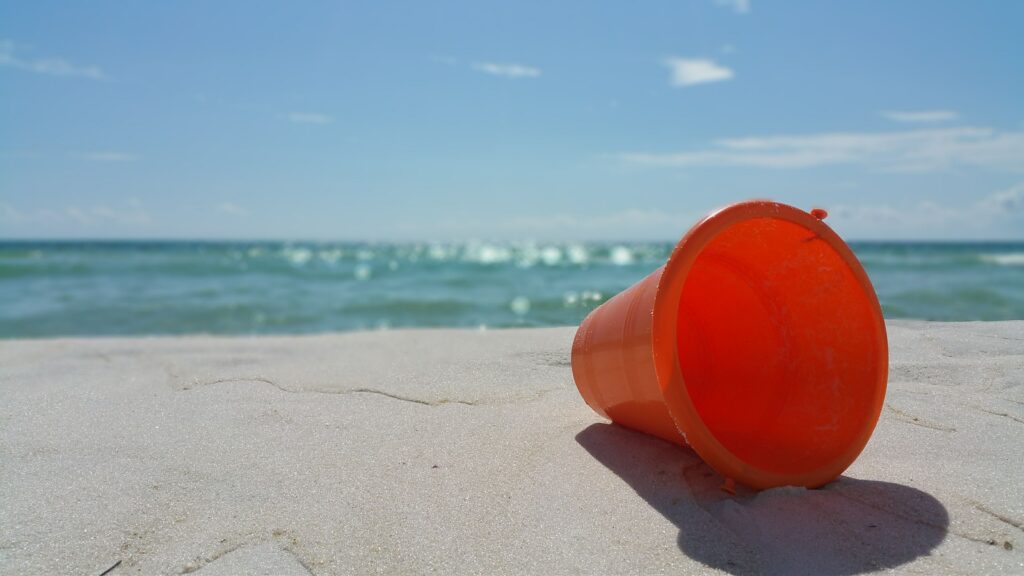 Orange Bucket on Beach (Logo)