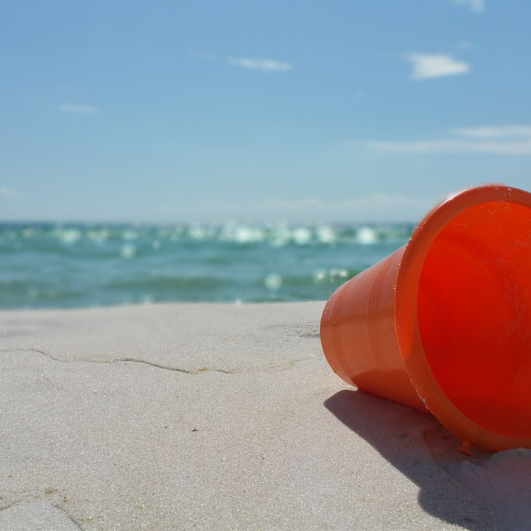 Orange Bucket on Beach (Logo)